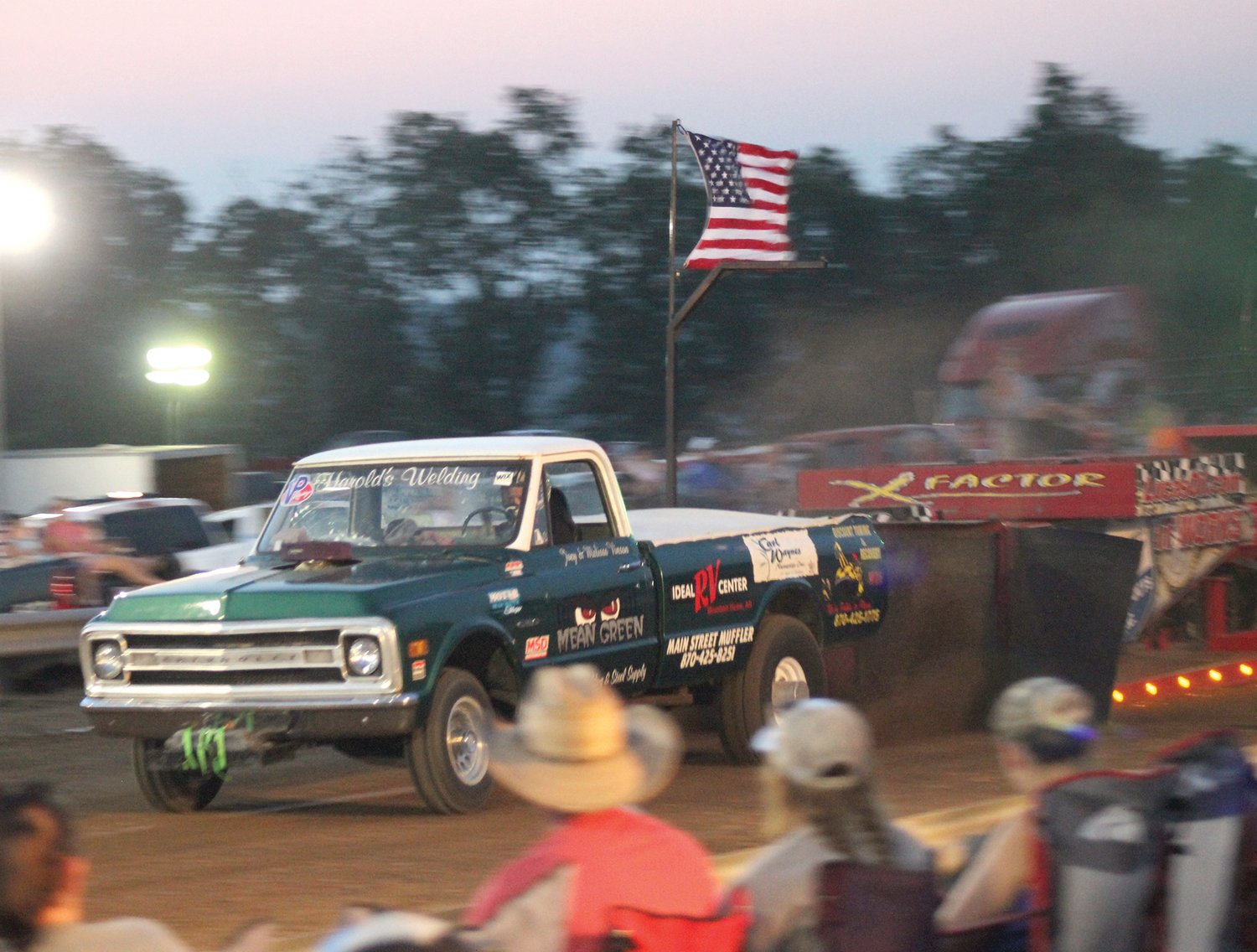 A truck named “Mean Green” pulls the sled down the course during the Truck and Tractor Pull event held at the Hartville Lions Club Arena on Saturday, Aug. 8.